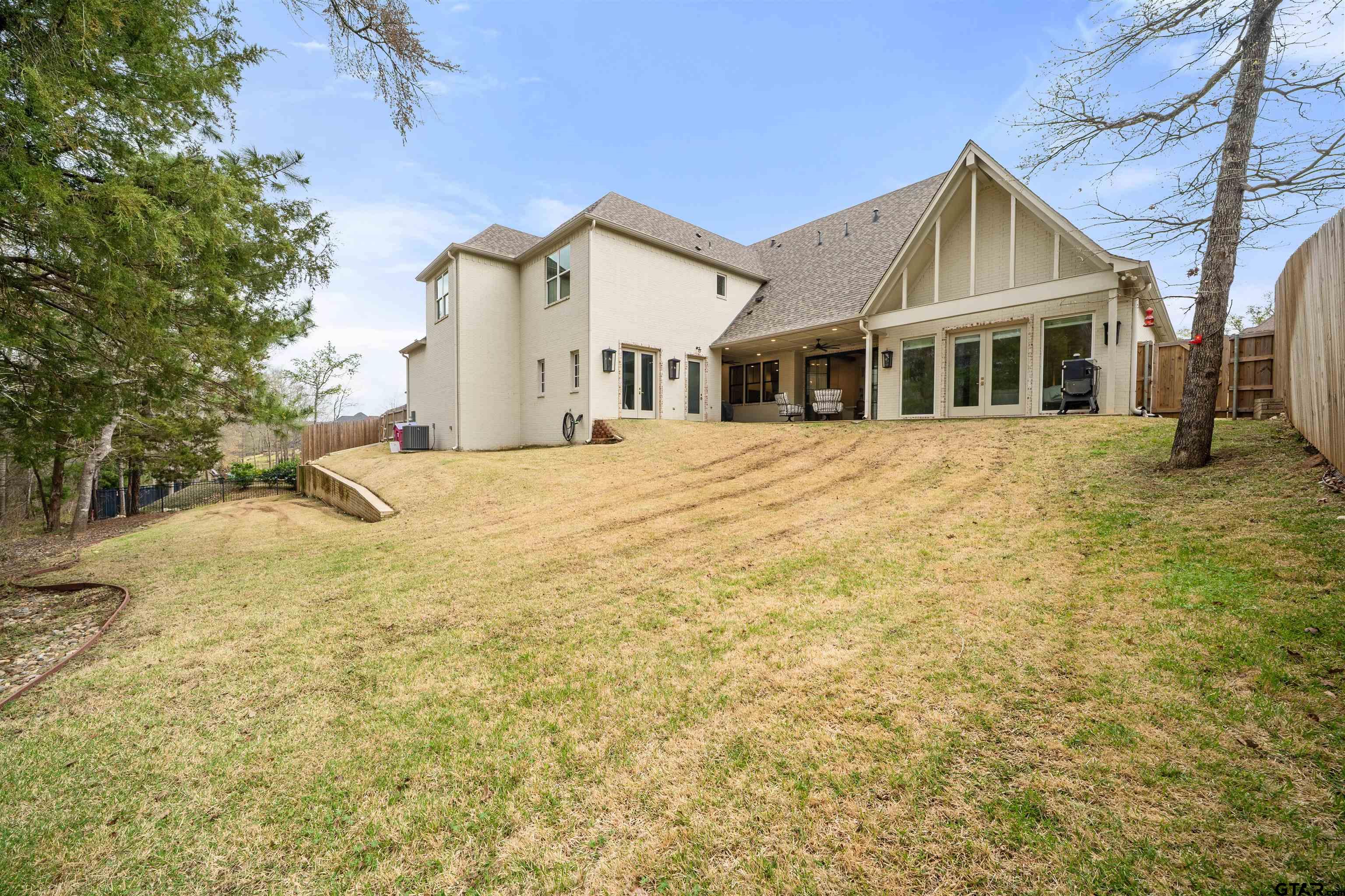 1555 Chaparrel Run Tyler, TX 75703 - Photo 45 of 48 a front view of a house with a yard and garage