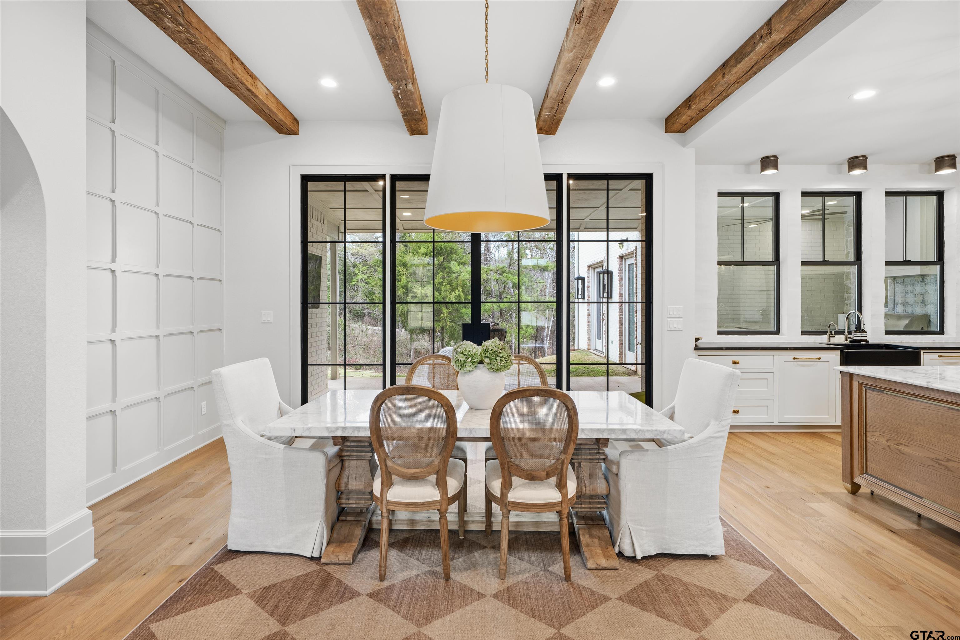 1555 Chaparrel Run Tyler, TX 75703 - Photo 5 of 48 a view of a dining room with furniture large windows and wooden floor