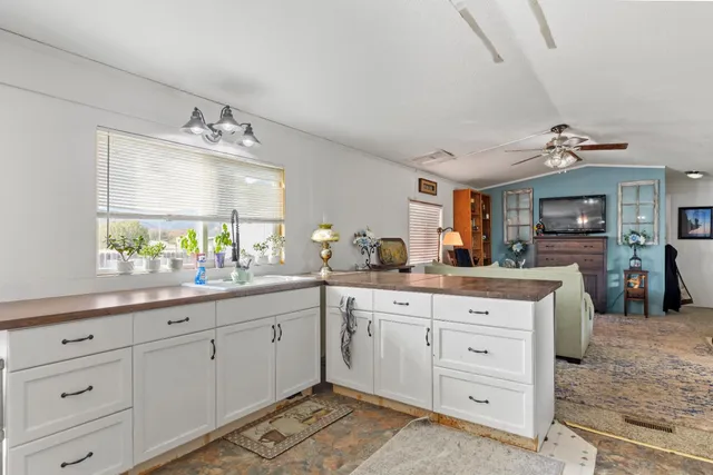 a kitchen with stainless steel appliances granite countertop a refrigerator and stove top oven