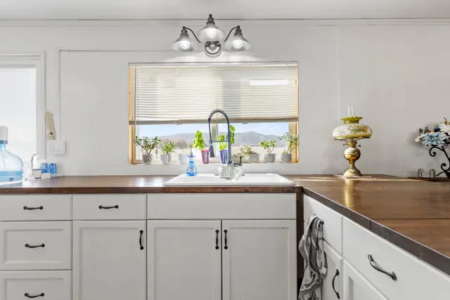 a kitchen with cabinets and window