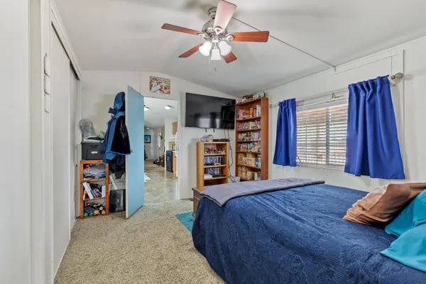 a bedroom with a bed and a chandelier