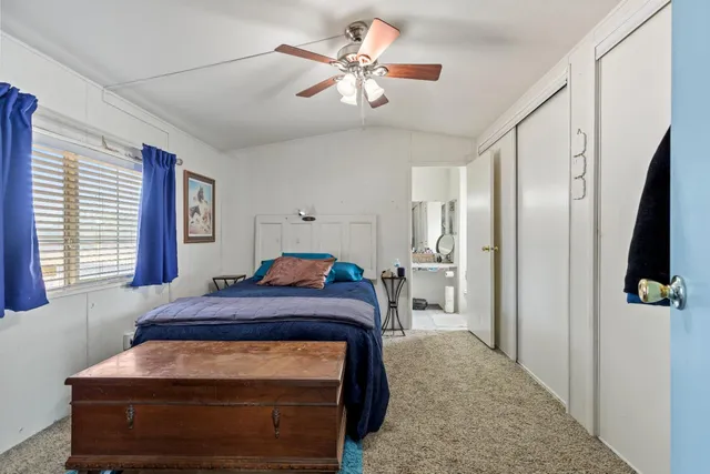 a room with a chandelier furniture and kitchen view