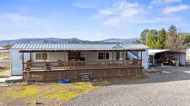 a view of a house with pool and a yard