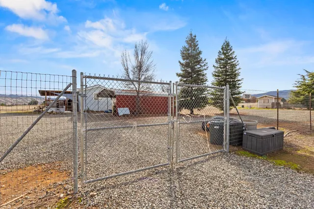 a view of a terrace with chairs and iron fence