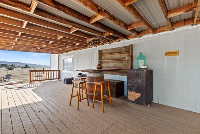 a view of hallway with wooden floor and stairs