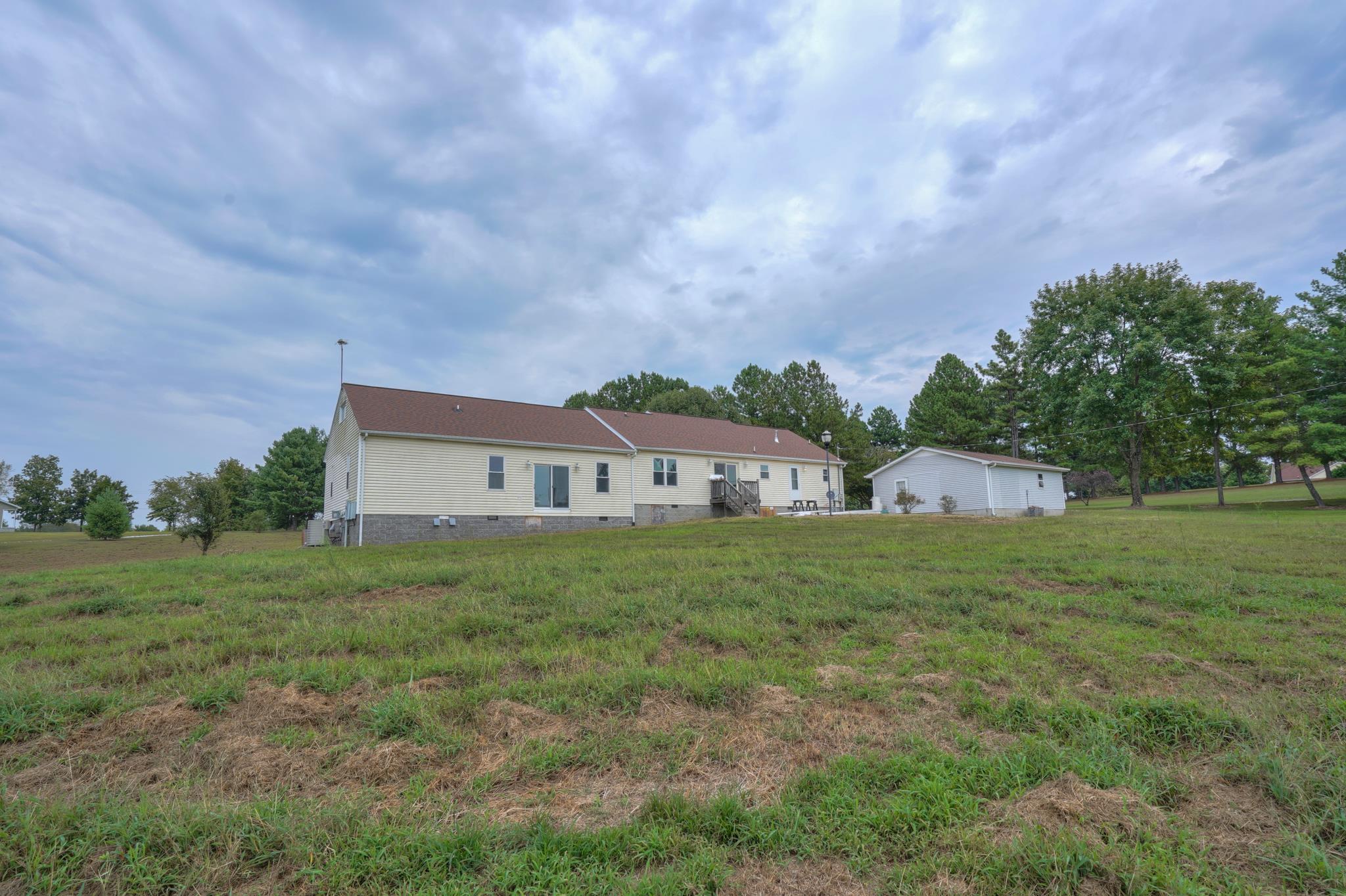 612 Murrell Road Dickson, TN 37055 - Photo 3 of 29 a view of a big house with a big yard plants and large trees