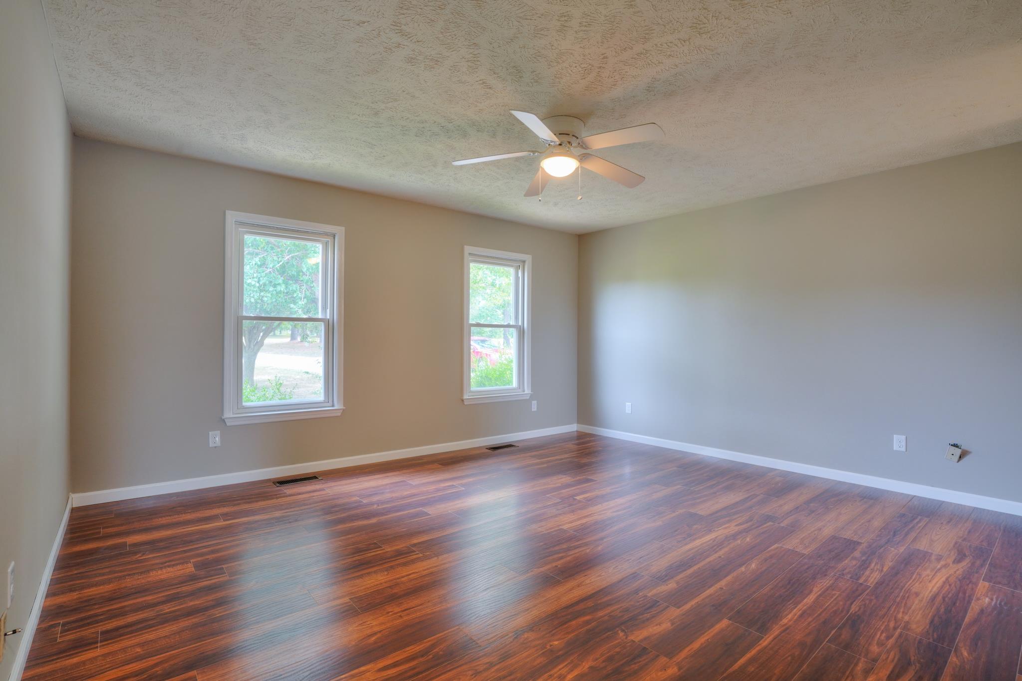 612 Murrell Road Dickson, TN 37055 - Photo 8 of 29 a view of an empty room with wooden floor and a window