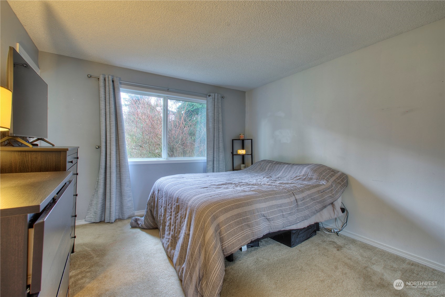 32607 35th Avenue Southwest Federal Way, WA 98023 - Photo 13 of 24 a bedroom with a bed and a flat tv screen on dresser