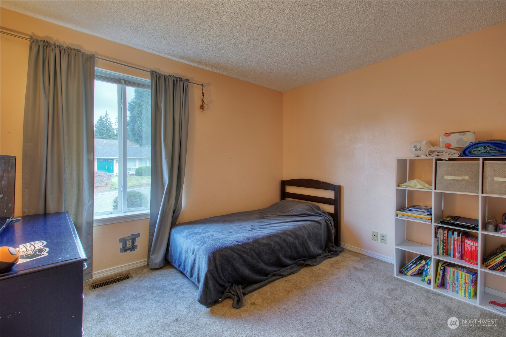 32607 35th Avenue Southwest Federal Way, WA 98023 - Photo 16 of 24 a bedroom with a bed and a book shelf