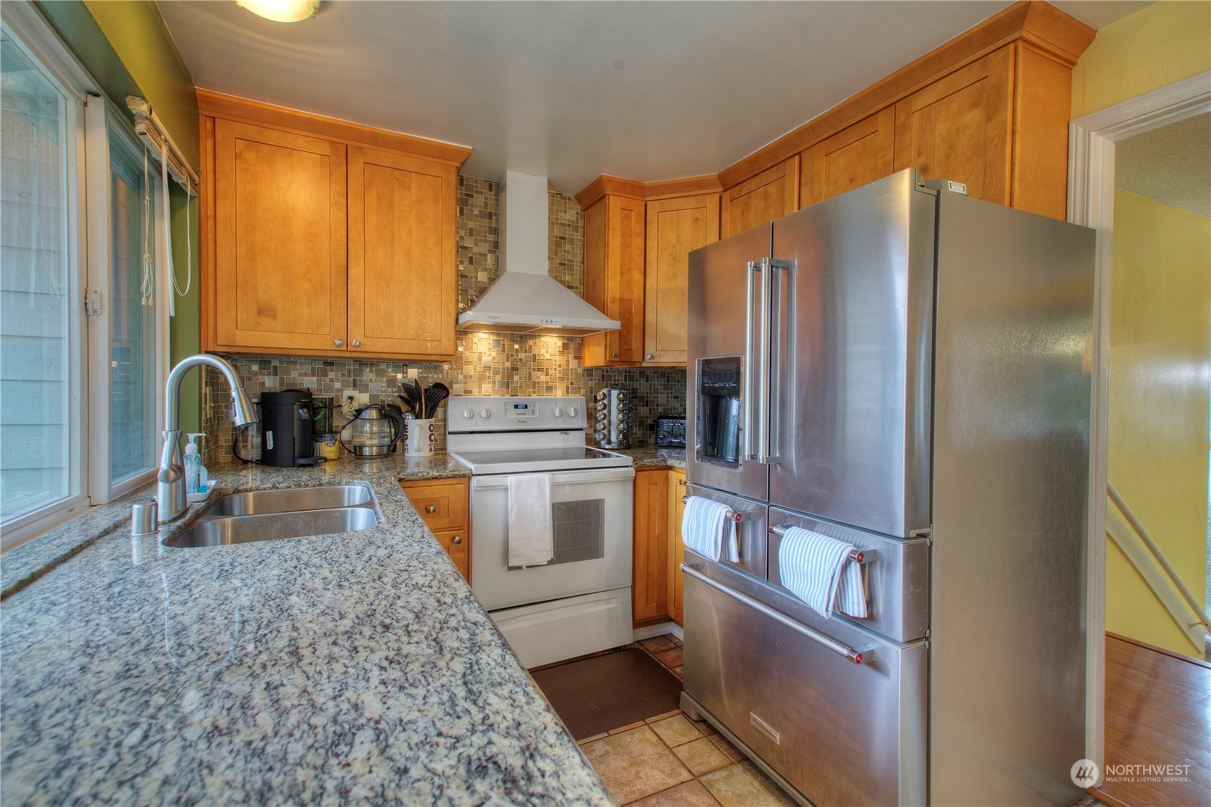 32607 35th Avenue Southwest Federal Way, WA 98023 - Photo 9 of 24 a kitchen with granite countertop a refrigerator and a stove top oven