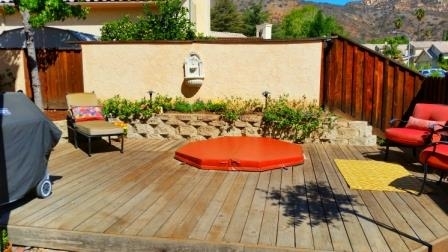 View of Backyard wood deck with built in relaxing Spa. Low maintenance and water wise.