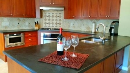 14229 Legacy Lane El Cajon, CA 92021 - Photo 8 of 25 Beautifully Upgraded Kitchen with Custom Cherry Cabinetry, SS Appliances, Soapstone counters, Tumbled Stone Backsplash, and Electrolux ICON Oven.