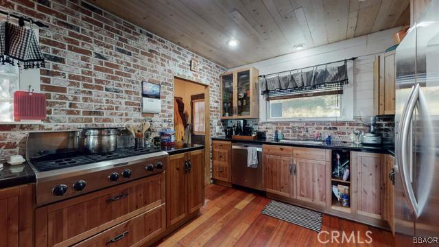 22013 Mojave River Road Cedarpines Park, CA 92322 - Photo 5 of 22 a kitchen with stainless steel appliances a stove sink and refrigerator
