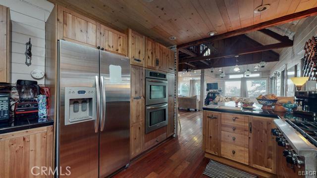 22013 Mojave River Road Cedarpines Park, CA 92322 - Photo 6 of 22 a kitchen with stainless steel appliances granite countertop a refrigerator and a stove
