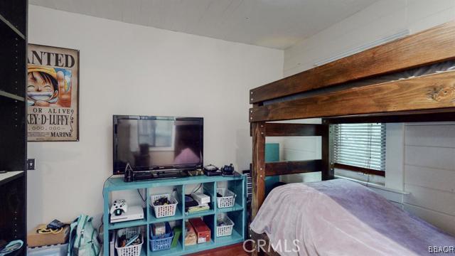 22013 Mojave River Road Cedarpines Park, CA 92322 - Photo 10 of 22 a bedroom with a bed and flat screen tv