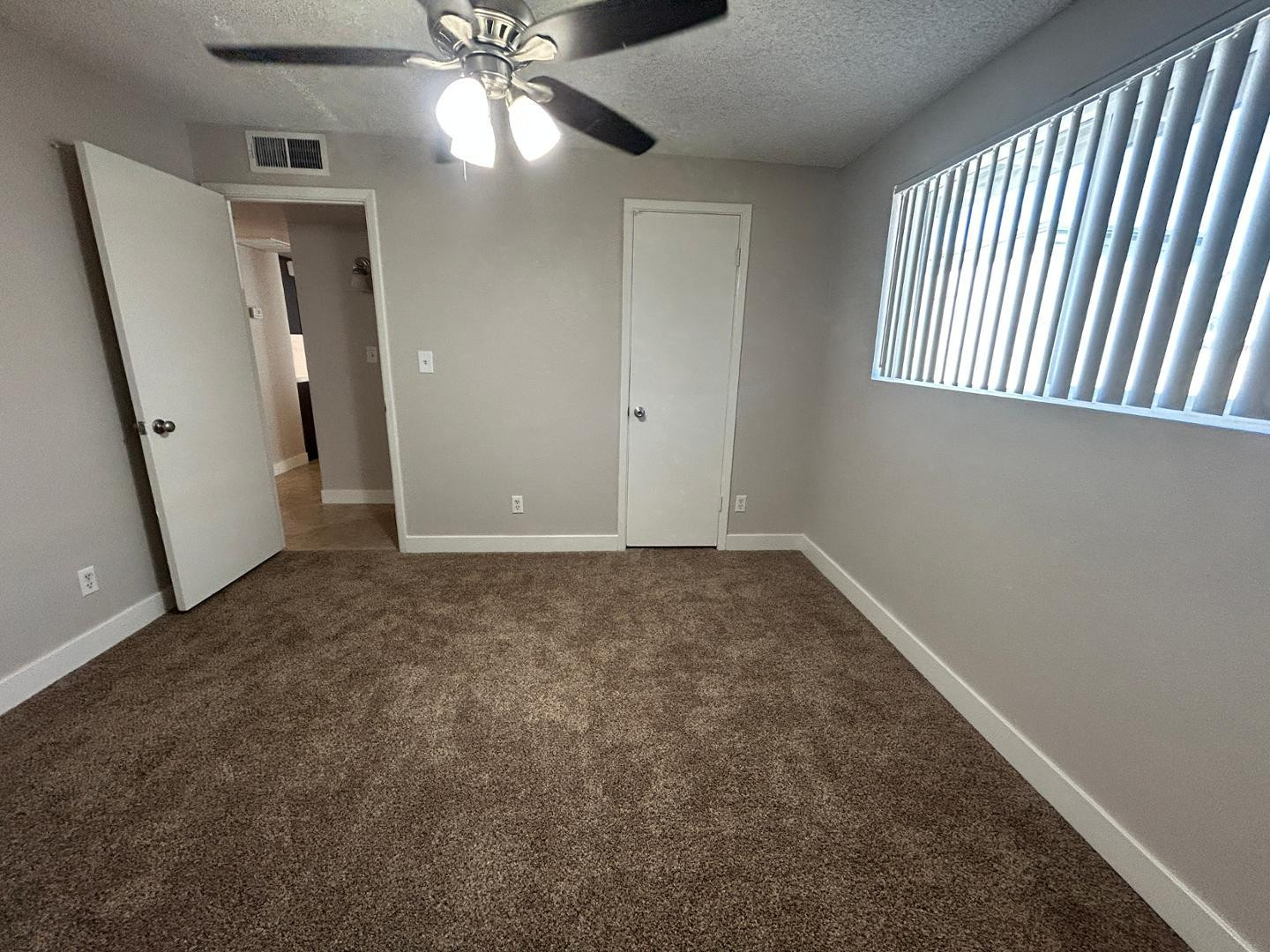 859 South Ext Road Mesa, AZ 85210 - Photo 12 of 19 an empty room with windows and fan