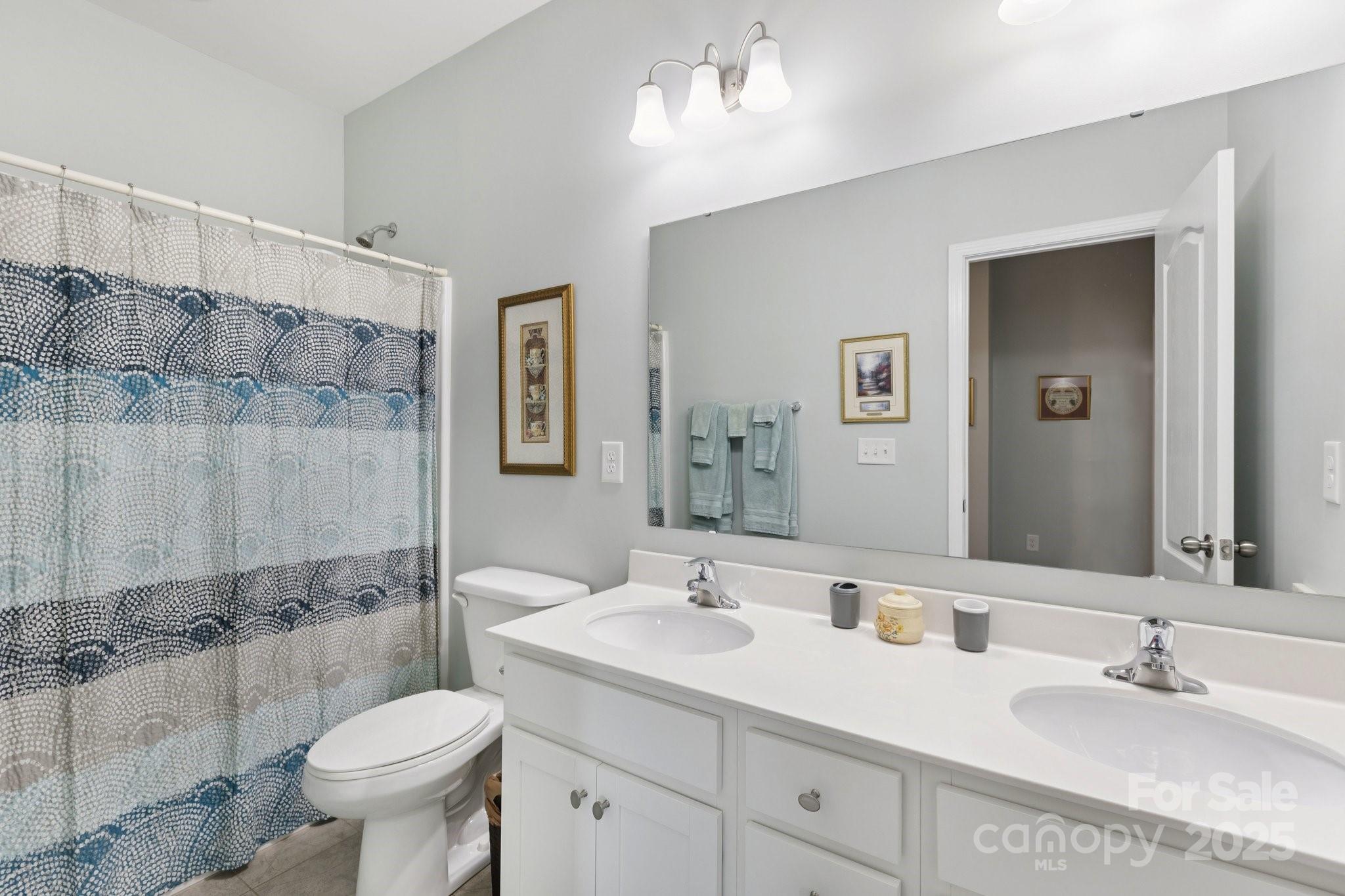 4236 Merrivale Drive Lancaster, SC 29720 - Photo 28 of 48 a bathroom with a double vanity sink toilet and a mirror