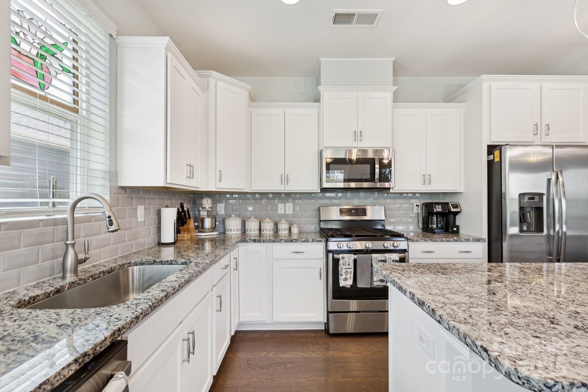 4236 Merrivale Drive Lancaster, SC 29720 - Photo 3 of 48 a kitchen with stainless steel appliances granite countertop a sink stove and refrigerator