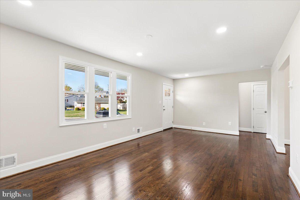 216 Cheddington Road Linthicum Heights, MD 21090 - Photo 13 of 60 an empty room with wooden floor and windows