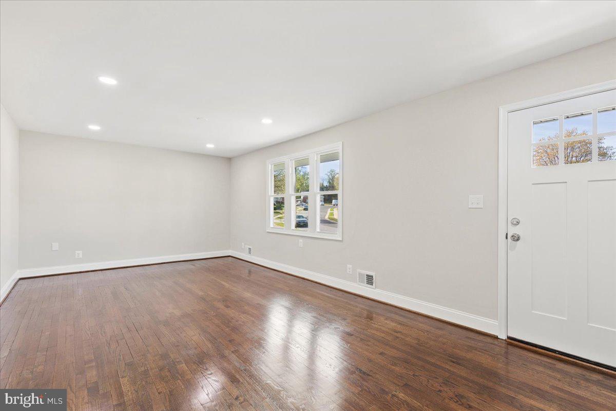 216 Cheddington Road Linthicum Heights, MD 21090 - Photo 14 of 60 an empty room with wooden floor and windows