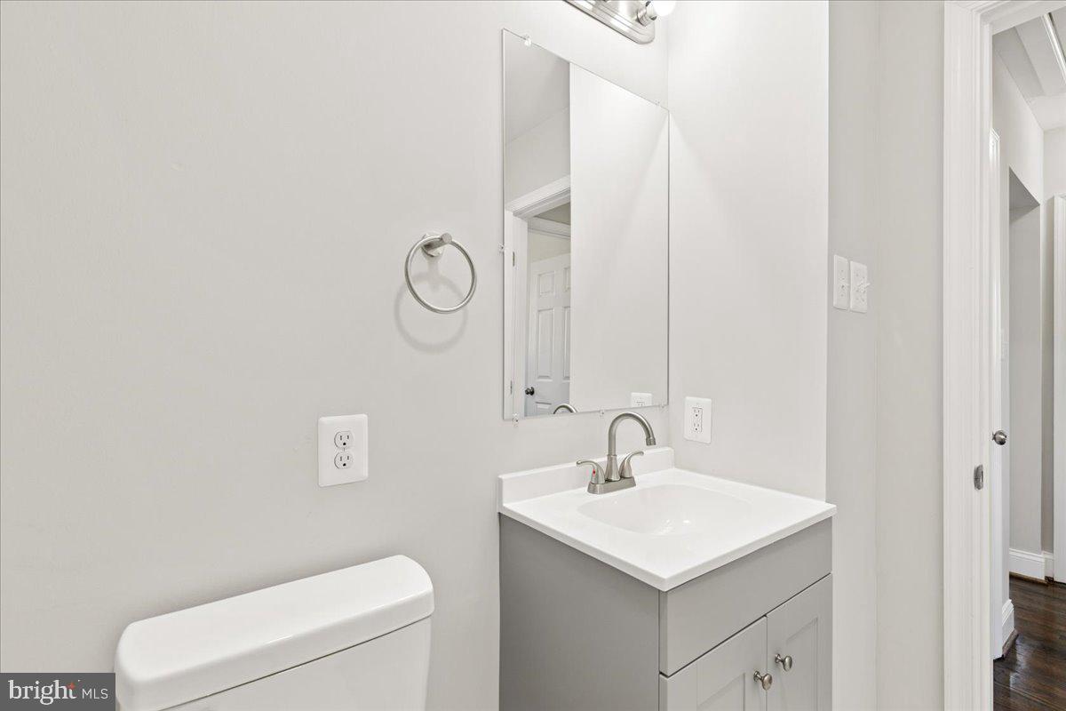 216 Cheddington Road Linthicum Heights, MD 21090 - Photo 24 of 60 a bathroom with a toilet sink and mirror