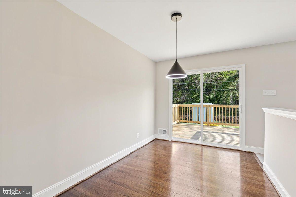 216 Cheddington Road Linthicum Heights, MD 21090 - Photo 25 of 60 a view of an empty room with wooden floor and a window