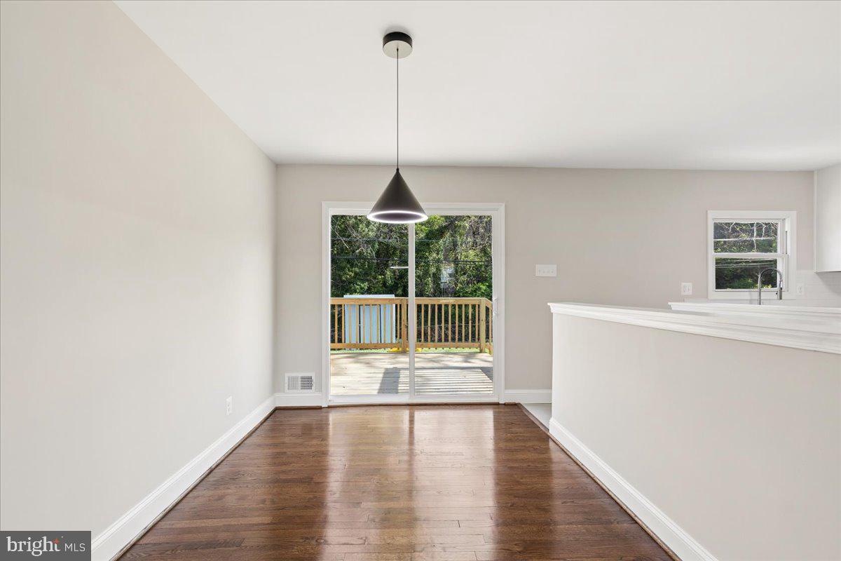216 Cheddington Road Linthicum Heights, MD 21090 - Photo 26 of 60 a view of a room with wooden floor and a window