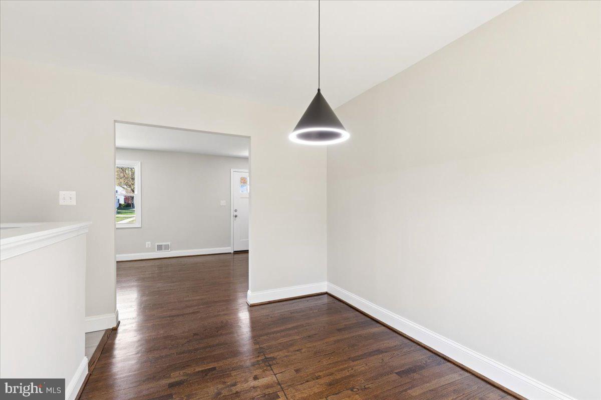 216 Cheddington Road Linthicum Heights, MD 21090 - Photo 29 of 60 a view of an empty room with wooden floor and a window