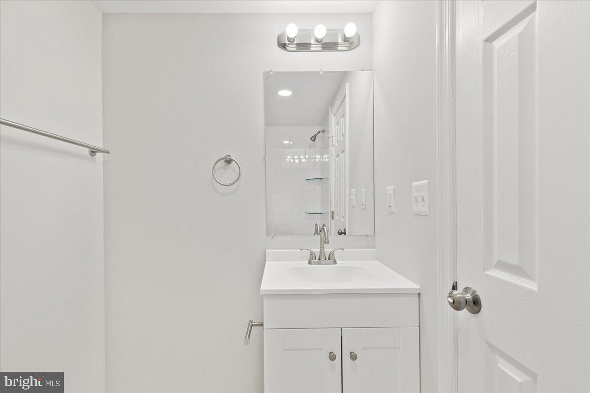 216 Cheddington Road Linthicum Heights, MD 21090 - Photo 50 of 60 a bathroom with a sink mirror and vanity