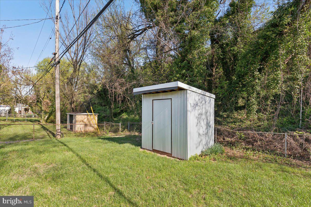 216 Cheddington Road Linthicum Heights, MD 21090 - Photo 57 of 60 a view of a wooden house with a yard
