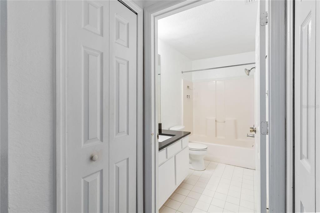 5459 Vineland Road, Unit 4208 Orlando, FL 32811 - Photo 16 of 29 a bathroom with a toilet a sink and shower