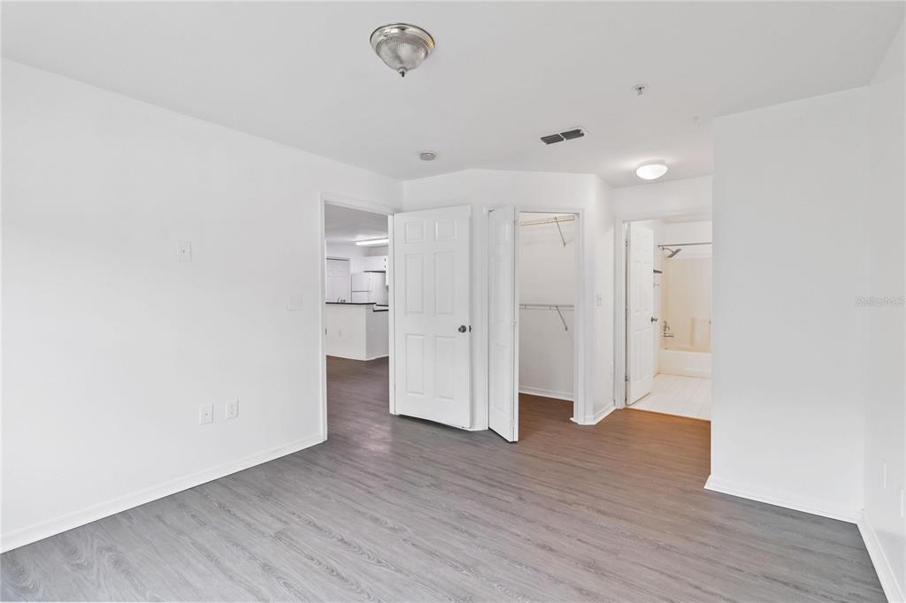 5459 Vineland Road, Unit 4208 Orlando, FL 32811 - Photo 18 of 29 a view of empty room with wooden floor
