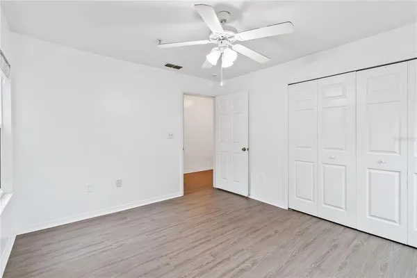 a view of an empty room with wooden floor