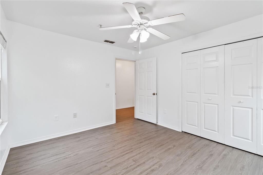 5459 Vineland Road, Unit 4208 Orlando, FL 32811 - Photo 21 of 29 a view of an empty room with wooden floor