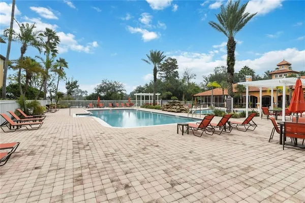 a view of swimming pool with sitting area