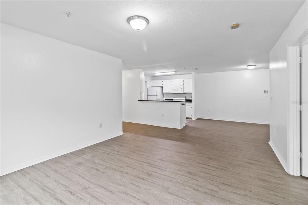 5459 Vineland Road, Unit 4208 Orlando, FL 32811 - Photo 7 of 29 a view of a kitchen with a sink and a refrigerator