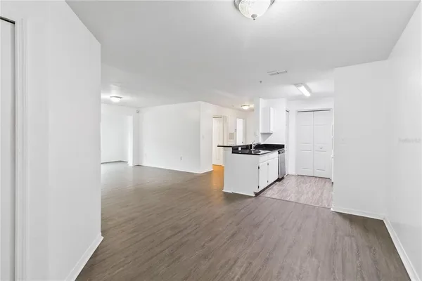 a view of kitchen with refrigerator sink and cabinets