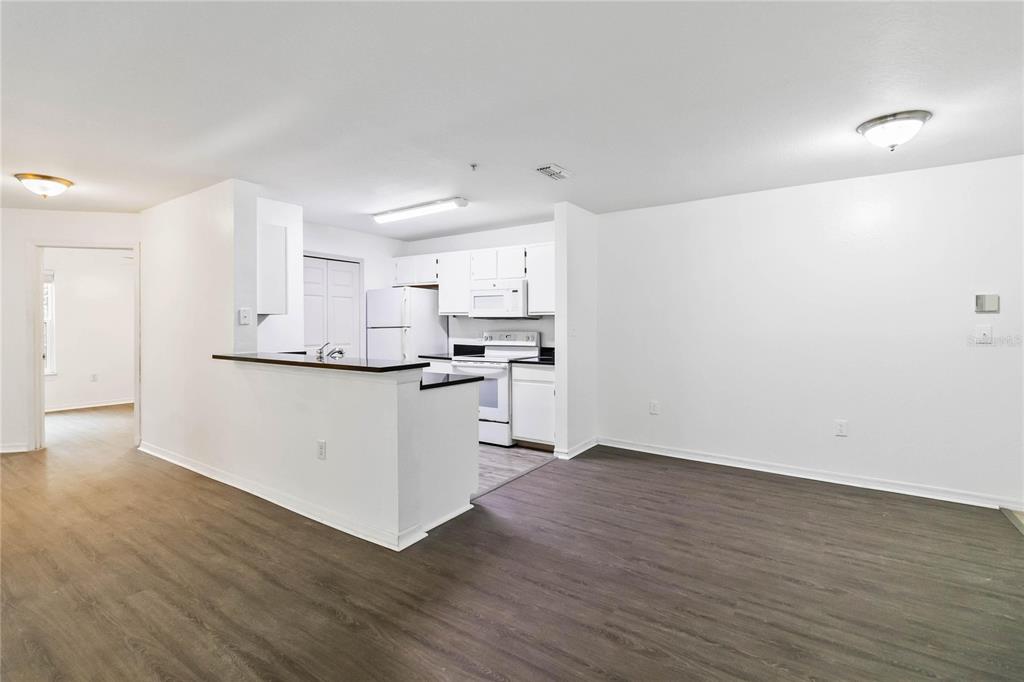 5459 Vineland Road, Unit 4208 Orlando, FL 32811 - Photo 9 of 29 a view of kitchen with wooden floor