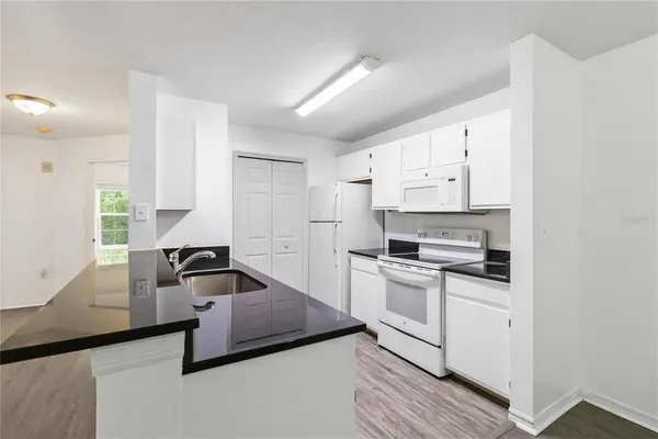 a kitchen with stainless steel appliances a stove a sink and a refrigerator