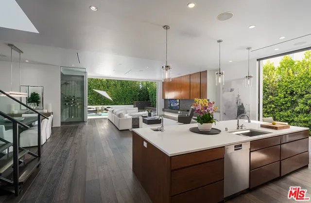 a kitchen with a sink stove and wooden floor