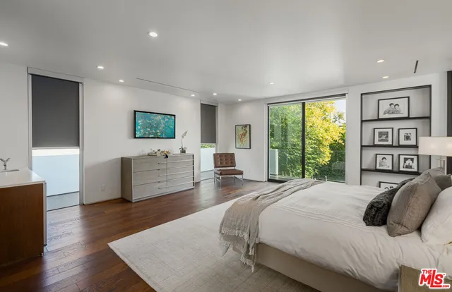 a bedroom with a large bed and a couch