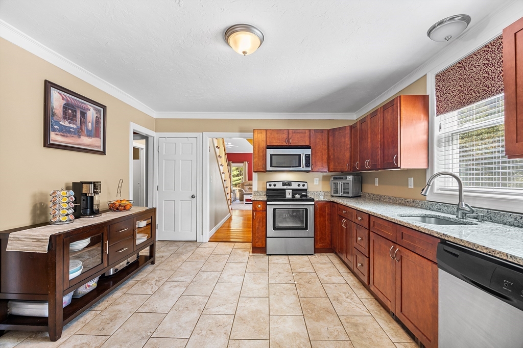 620 Whitney Street Gardner, MA 01440 - Photo 12 of 39 a kitchen with stainless steel appliances granite countertop a stove top oven a sink dishwasher and a refrigerator