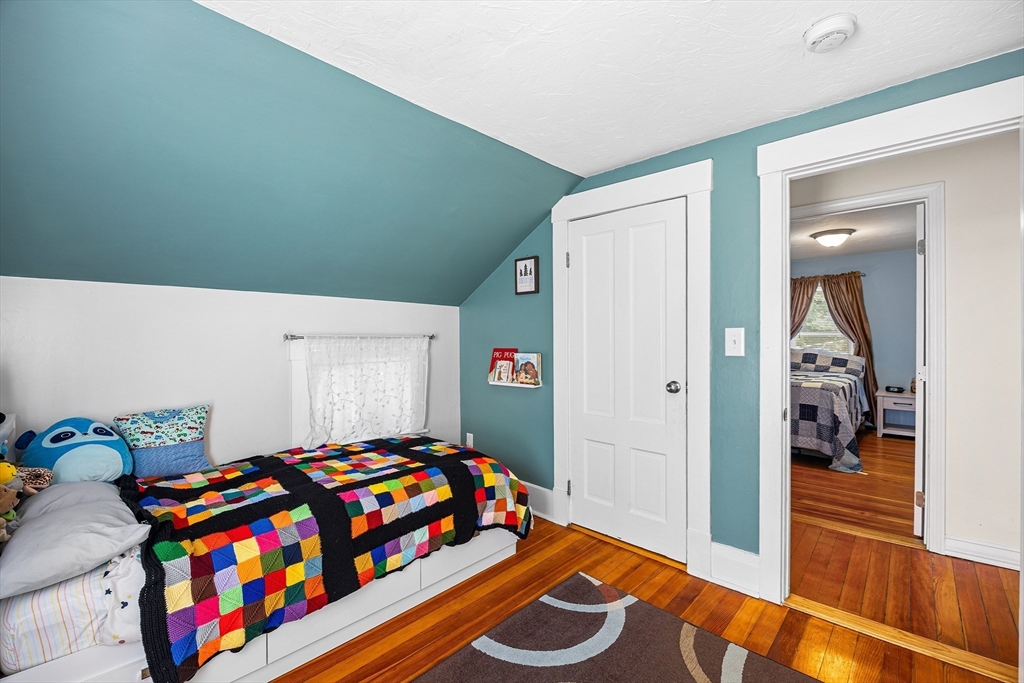 620 Whitney Street Gardner, MA 01440 - Photo 16 of 39 a bedroom with a bed and wooden floor