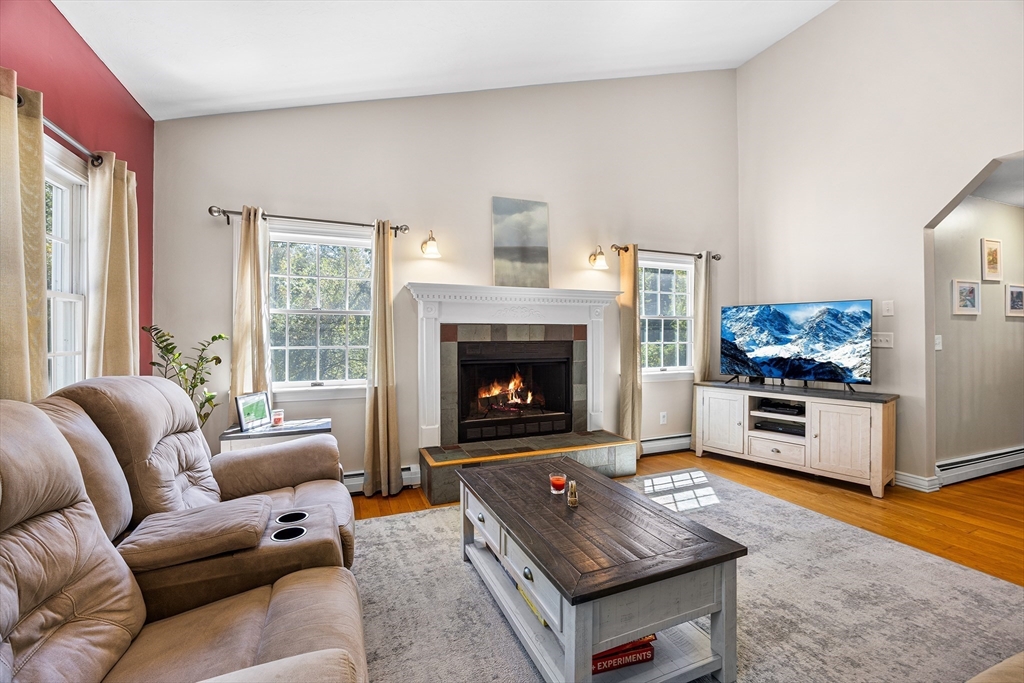 620 Whitney Street Gardner, MA 01440 - Photo 3 of 39 a living room with furniture a flat screen tv and a fireplace