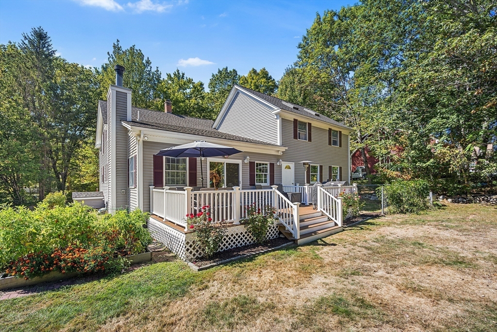 620 Whitney Street Gardner, MA 01440 - Photo 35 of 39 a front view of a house with a garden and trees