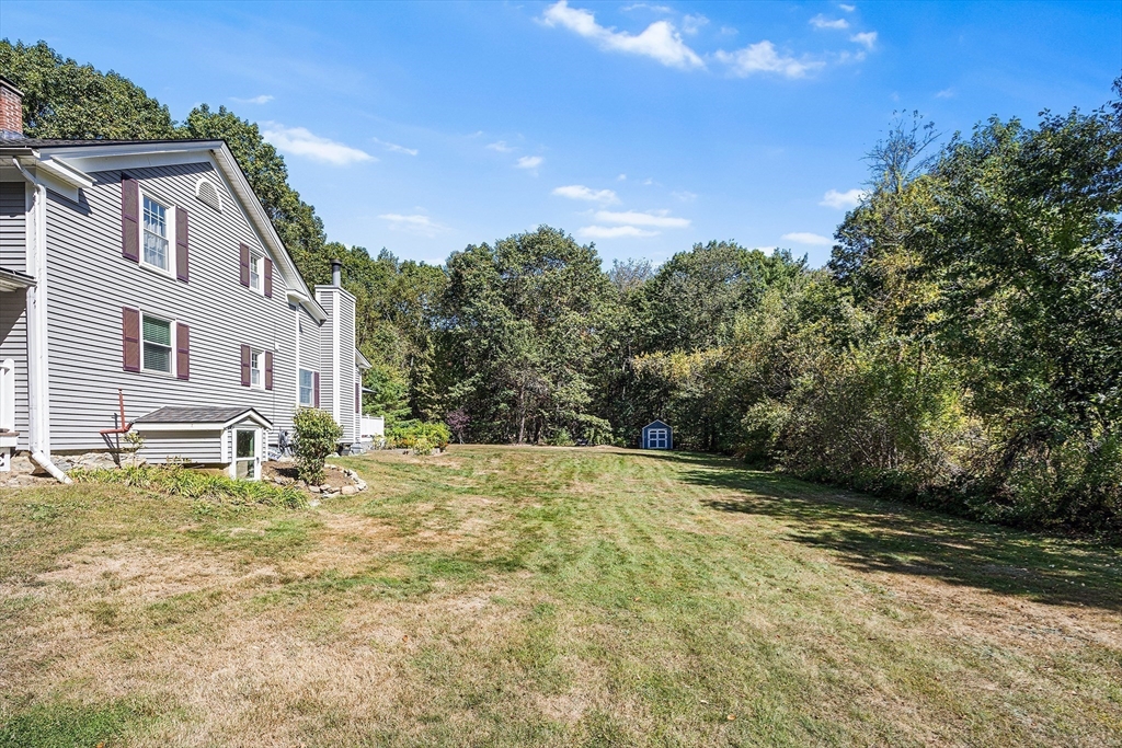 620 Whitney Street Gardner, MA 01440 - Photo 38 of 39 a backyard of a house with large trees
