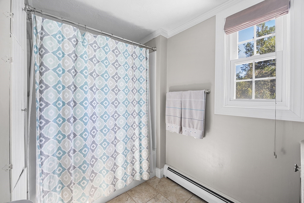 620 Whitney Street Gardner, MA 01440 - Photo 8 of 39 a bathroom with a shower curtain and a window