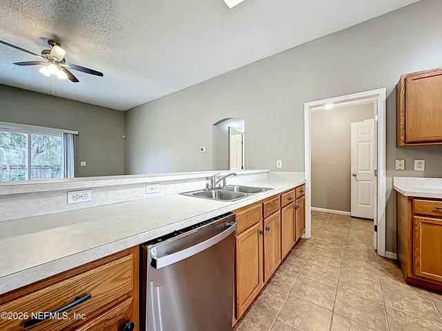 a kitchen with a sink and a refrigerator