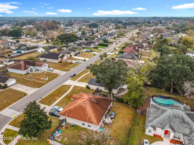 an aerial view of residential houses with outdoor space