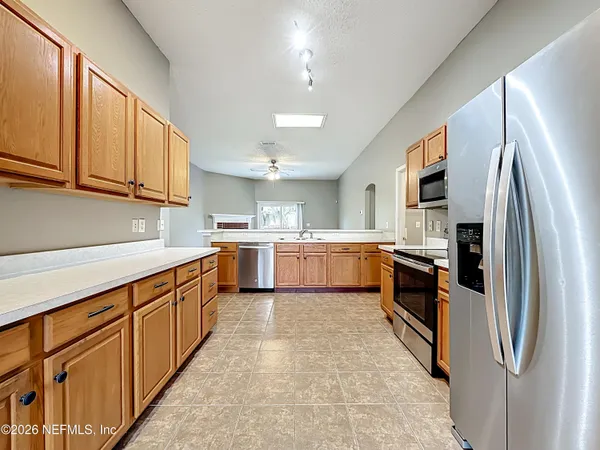 a kitchen with stainless steel appliances granite countertop a refrigerator sink and cabinets